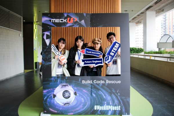 Students taking commemorative photos at the event check-in area